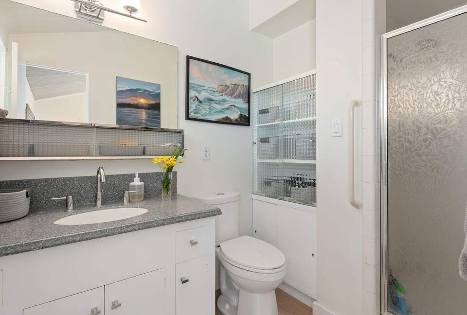 Primary private en suite bathroom with tile shower